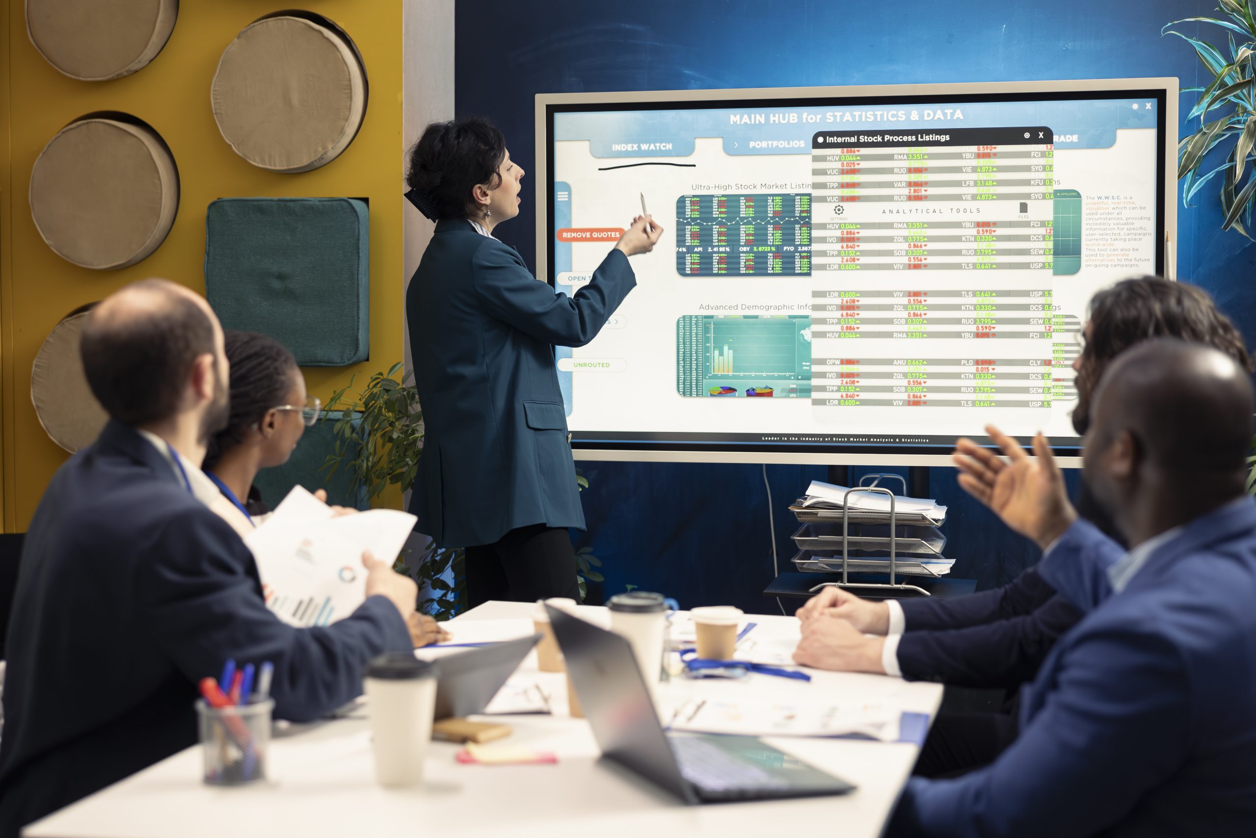 Business partners examining annual sales reports in corporate meeting